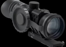 Black rifle scope with adjustment turrets and a mounting rail against a black background, ready for aiming gear