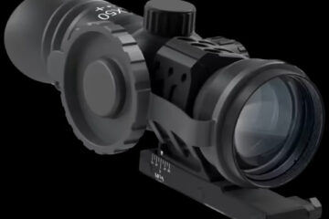 Black rifle scope with adjustment turrets and a mounting rail against a black background, ready for aiming gear